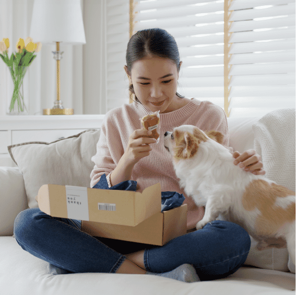 customer opening subscription box with pet